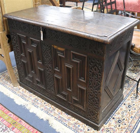 A carved oak coffer W.104cm